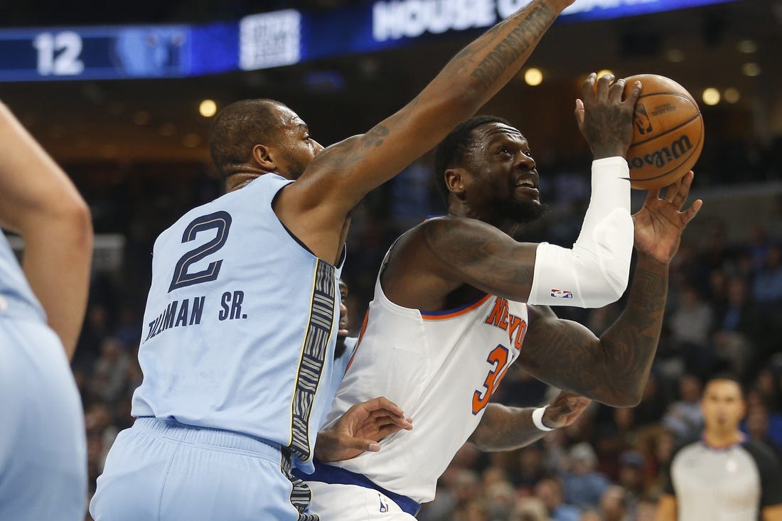 Jan 13, 2024; Memphis, Tennessee, USA; New York Knicks forward Julius Randle (30) drives to the basket as Memphis Grizzlies forward Xavier Tillman (2) defends during the first half at FedExForum. Mandatory Credit: Petre Thomas-USA TODAY Sports