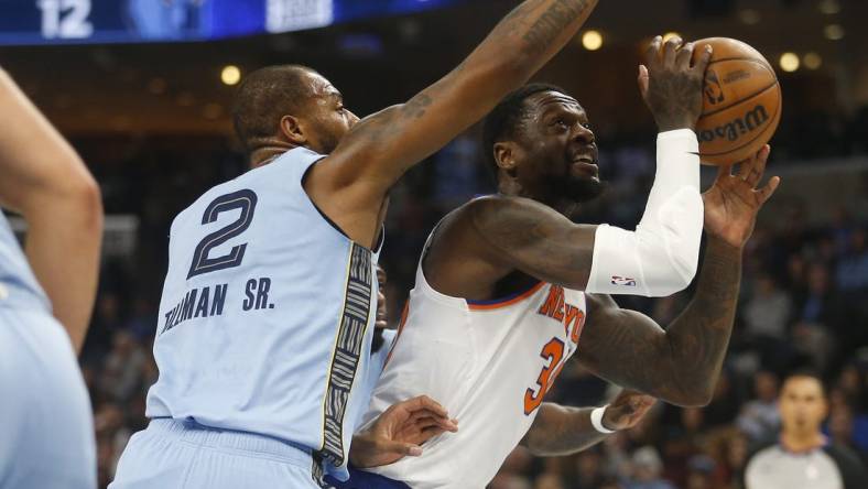 Jan 13, 2024; Memphis, Tennessee, USA; New York Knicks forward Julius Randle (30) drives to the basket as Memphis Grizzlies forward Xavier Tillman (2) defends during the first half at FedExForum. Mandatory Credit: Petre Thomas-USA TODAY Sports