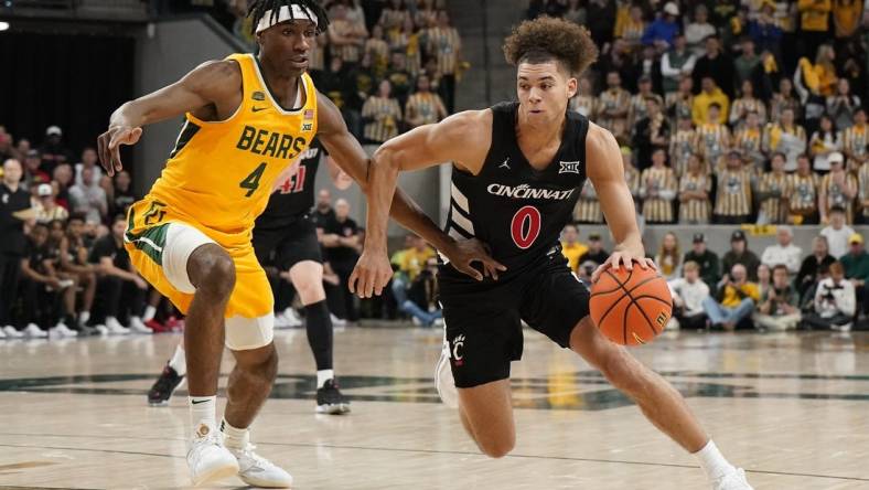 Jan 13, 2024; Waco, Texas, USA; Cincinnati Bearcats guard Dan Skillings Jr. (0) works around Baylor Bears guard Ja'Kobe Walter (4) during the first half at Paul and Alejandra Foster Pavilion. Mandatory Credit: Raymond Carlin III-USA TODAY Sports