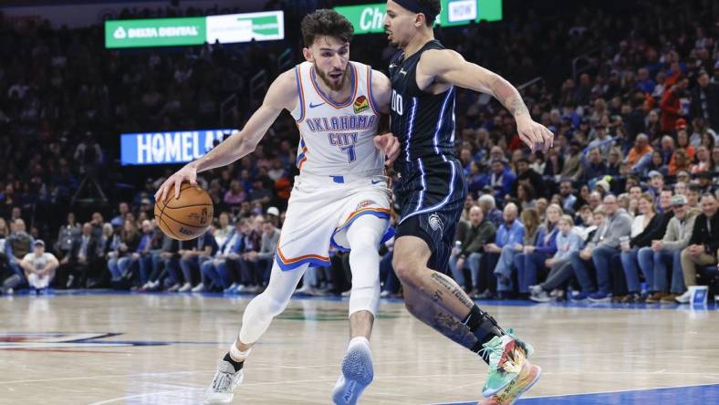 Jan 13, 2024; Oklahoma City, Oklahoma, USA; Oklahoma City Thunder forward Chet Holmgren (7) drives to the basket against Orlando Magic guard Cole Anthony (50) during the second half at Paycom Center. Mandatory Credit: Alonzo Adams-USA TODAY Sports