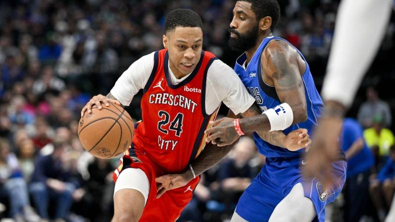 Jan 13, 2024; Dallas, Texas, USA; New Orleans Pelicans guard Jordan Hawkins (24) drives to the basket past Dallas Mavericks guard Kyrie Irving (11) during the second half at the American Airlines Center. Mandatory Credit: Jerome Miron-USA TODAY Sports