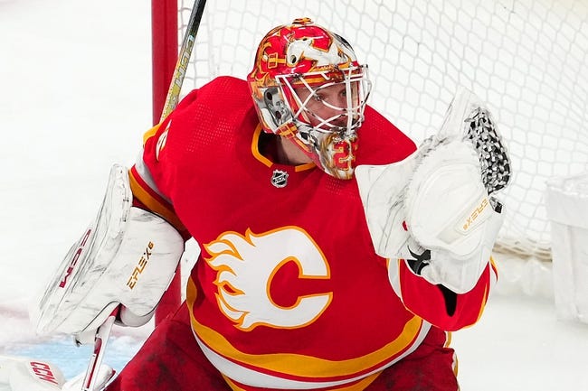 Jan 13, 2024; Las Vegas, Nevada, USA; Calgary Flames goaltender Jacob Markstrom (25) makes a glove save against the Vegas Golden Knights during the third period at T-Mobile Arena. Mandatory Credit: Stephen R. Sylvanie-USA TODAY Sports