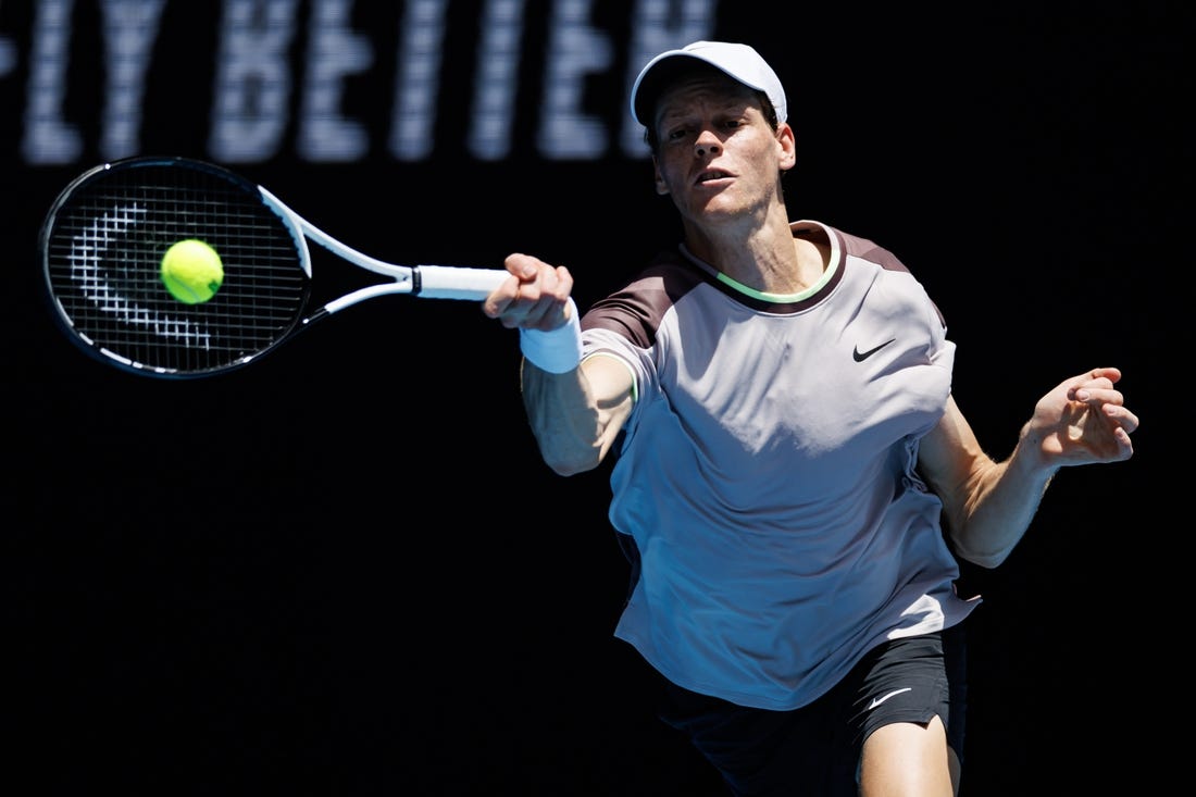 Jan 14, 2024; Melbourne, Victoria, Australia;   Jannik Sinner of Italy hits a shot against Botic Van De Zandschulp of the Netherlands in the first round of the men s singles. Mandatory Credit: Mike Frey-USA TODAY Sports