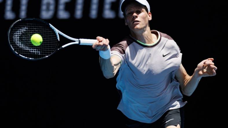 Jan 14, 2024; Melbourne, Victoria, Australia;   Jannik Sinner of Italy hits a shot against Botic Van De Zandschulp of the Netherlands in the first round of the men s singles. Mandatory Credit: Mike Frey-USA TODAY Sports