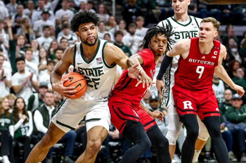 Michigan State's Malik Hall, left, looks for room as Rutgers' Jamichael Davis defends during the first half on Sunday, Jan. 14, 2024, at the Breslin Center in East Lansing.