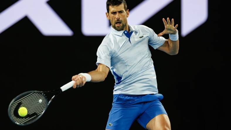 Jan 14, 2024; Melbourne, Victoria, Australia;  Novak Djokovic of Serbia hits a shot against Dino Prizmic of Croatia in the first round of the men   s singles. Mandatory Credit: Mike Frey-USA TODAY Sports