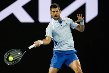 Jan 14, 2024; Melbourne, Victoria, Australia;  Novak Djokovic of Serbia hits a shot against Dino Prizmic of Croatia in the first round of the men   s singles. Mandatory Credit: Mike Frey-USA TODAY Sports