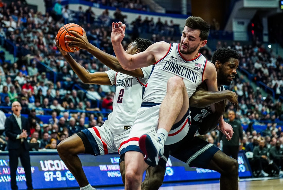 Jan 14, 2024; Hartford, Connecticut, USA; Georgetown Hoyas forward Supreme Cook (24) called for the foul against Connecticut Huskies forward Alex Karaban (11) in the first half at XL Center. Mandatory Credit: David Butler II-USA TODAY Sports