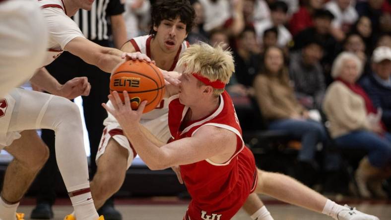 Jan 14, 2024; Stanford, California, USA; Utah Utes guard Hunter Erickson (right) competes for a loose ball with Stanford Cardinal forward Maxime Raynaud (left) and guard Benny Gealer during the first half at Maples Pavilion. Mandatory Credit: D. Ross Cameron-USA TODAY Sports