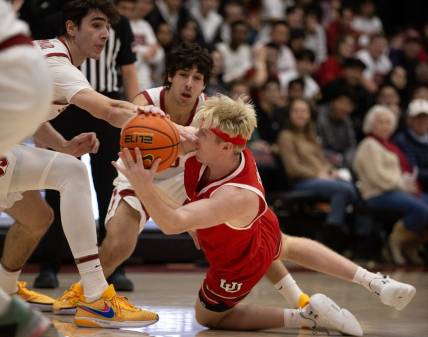 Jan 14, 2024; Stanford, California, USA; Utah Utes guard Hunter Erickson (right) competes for a loose ball with Stanford Cardinal forward Maxime Raynaud (left) and guard Benny Gealer during the first half at Maples Pavilion. Mandatory Credit: D. Ross Cameron-USA TODAY Sports