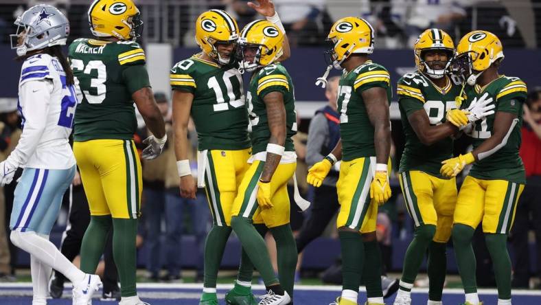 Jan 14, 2024; Arlington, Texas, USA; Green Bay Packers quarterback Jordan Love (10) reacts with wide receiver Dontayvion Wicks (13) after a touchdown catch in the first half of the 2024 NFC wild card game at AT&T Stadium. Mandatory Credit: Kevin Jairaj-USA TODAY Sports