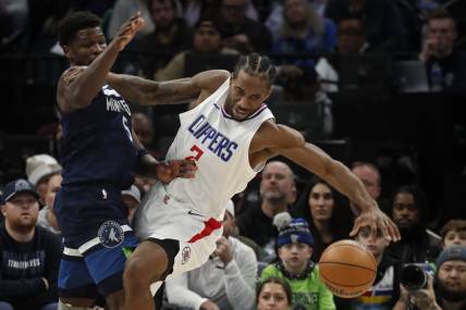 Jan 14, 2024; Minneapolis, Minnesota, USA; Minnesota Timberwolves guard Anthony Edwards (5) defends against Los Angeles Clippers forward Kawhi Leonard (2) in the first quarter at Target Center. Mandatory Credit: Bruce Kluckhohn-USA TODAY Sports