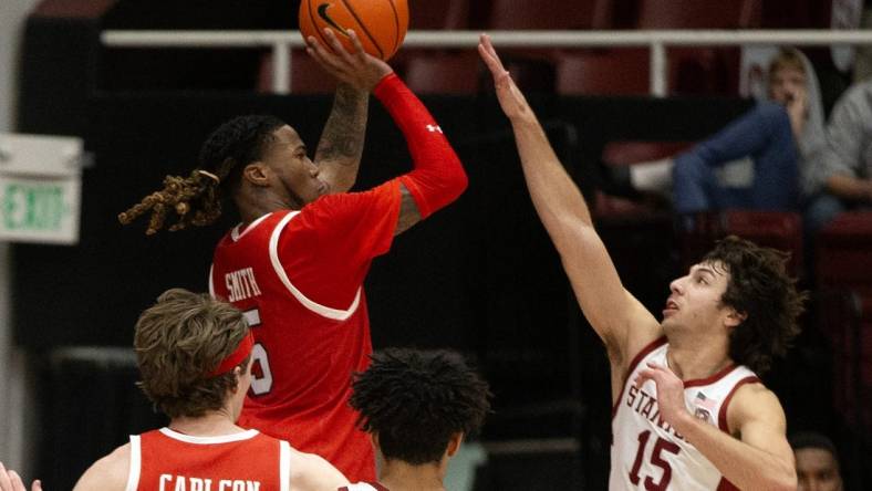 Jan 14, 2024; Stanford, California, USA; Utah Utes guard Deivon Smith (5) shoots over Stanford Cardinal guard Benny Gealer (15) during the second half at Maples Pavilion. Mandatory Credit: D. Ross Cameron-USA TODAY Sports