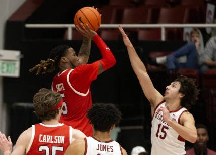 Jan 14, 2024; Stanford, California, USA; Utah Utes guard Deivon Smith (5) shoots over Stanford Cardinal guard Benny Gealer (15) during the second half at Maples Pavilion. Mandatory Credit: D. Ross Cameron-USA TODAY Sports