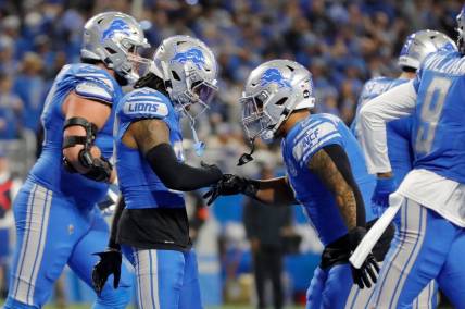 Detroit Lions running back Jahmyr Gibbs and Detroit Lions running back David Montgomery celebrate after Gibbs scored a touchdown in the first half against the L.A. Rams at Ford Field in Detroit on Sunday, Jan. 14, 2023.
