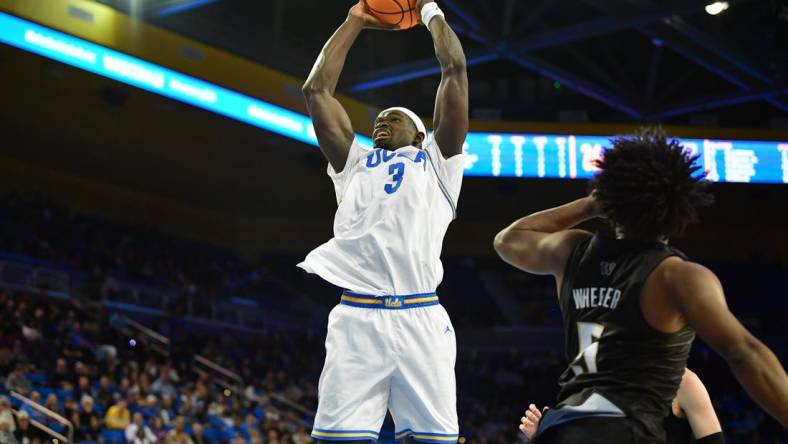 January 14, 2024; Los Angeles, California, USA; UCLA Bruins forward Adem Bona (3) moves to the basket against Washington Huskies guard Sahvir Wheeler (5) during the second half at Pauley Pavilion. Mandatory Credit: Gary A. Vasquez-USA TODAY Sports