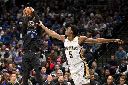 Jan 15, 2024; Dallas, Texas, USA; Dallas Mavericks guard Kyrie Irving (11) shoots the ball over New Orleans Pelicans forward Herbert Jones (5) during the second quarter at the American Airlines Center. Mandatory Credit: Jerome Miron-USA TODAY Sports