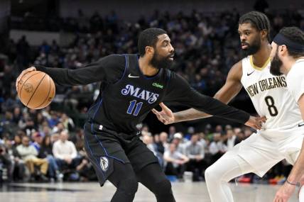 Jan 15, 2024; Dallas, Texas, USA; Dallas Mavericks guard Kyrie Irving (11) looks to move the ball past New Orleans Pelicans forward Naji Marshall (8) during the second quarter at the American Airlines Center. Mandatory Credit: Jerome Miron-USA TODAY Sports