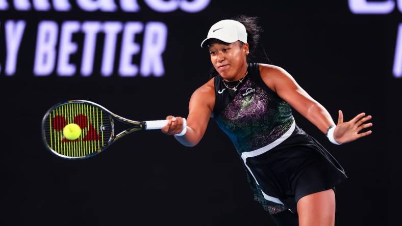 Jan 15, 2024; Melbourne, Victoria, Australia; Naomi Osaka of Japan plays a shot against Caroline Garcia (not pictured) of France in Round 1 of the Women's Singles on Day 2 of the Australian Open tennis at Rod Laver Arena. Mandatory Credit: Mike Frey-USA TODAY Sports