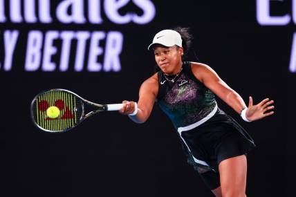 Jan 15, 2024; Melbourne, Victoria, Australia; Naomi Osaka of Japan plays a shot against Caroline Garcia (not pictured) of France in Round 1 of the Women's Singles on Day 2 of the Australian Open tennis at Rod Laver Arena. Mandatory Credit: Mike Frey-USA TODAY Sports
