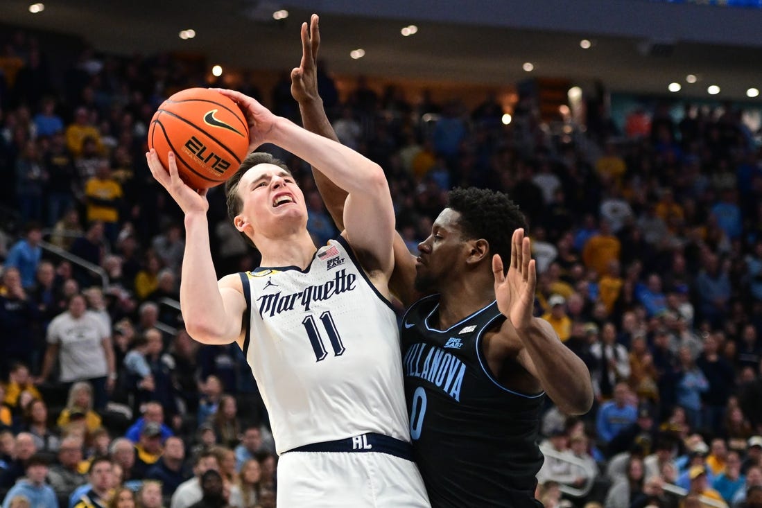 Jan 15, 2024; Milwaukee, Wisconsin, USA; Marquette Golden Eagles guard Tyler Kolek (11) takes a shot against Villanova Wildcats guard TJ Bamba (0) in the second half at Fiserv Forum. Mandatory Credit: Benny Sieu-USA TODAY Sports