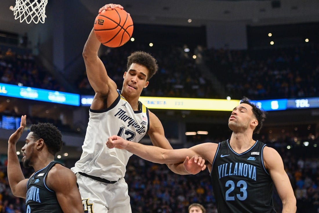 Jan 15, 2024; Milwaukee, Wisconsin, USA; Marquette Golden Eagles forward Oso Ighodaro (13) and Villanova Wildcats forward Tyler Burton (23) reach for a rebound in the second half at Fiserv Forum. Mandatory Credit: Benny Sieu-USA TODAY Sports