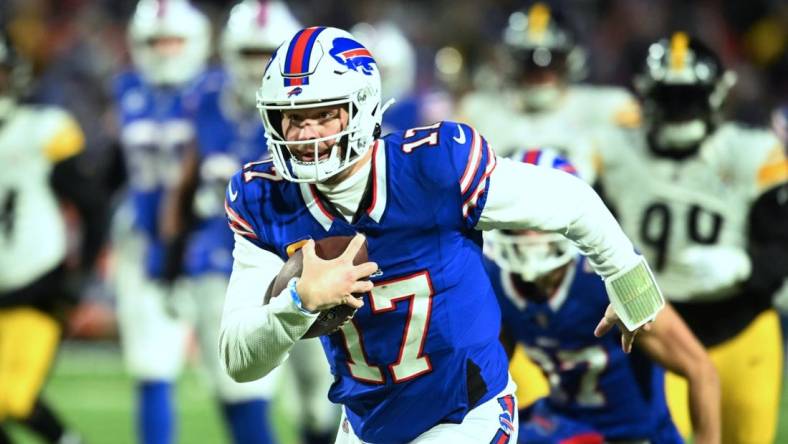 Jan 15, 2024; Orchard Park, New York, USA; Buffalo Bills quarterback Josh Allen (17) runs the ball in the first half against the Pittsburgh Steelers in a 2024 AFC wild card game at Highmark Stadium. Mandatory Credit: Mark Konezny-USA TODAY Sports