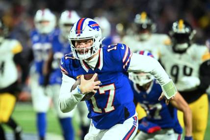 Jan 15, 2024; Orchard Park, New York, USA; Buffalo Bills quarterback Josh Allen (17) runs the ball in the first half against the Pittsburgh Steelers in a 2024 AFC wild card game at Highmark Stadium. Mandatory Credit: Mark Konezny-USA TODAY Sports
