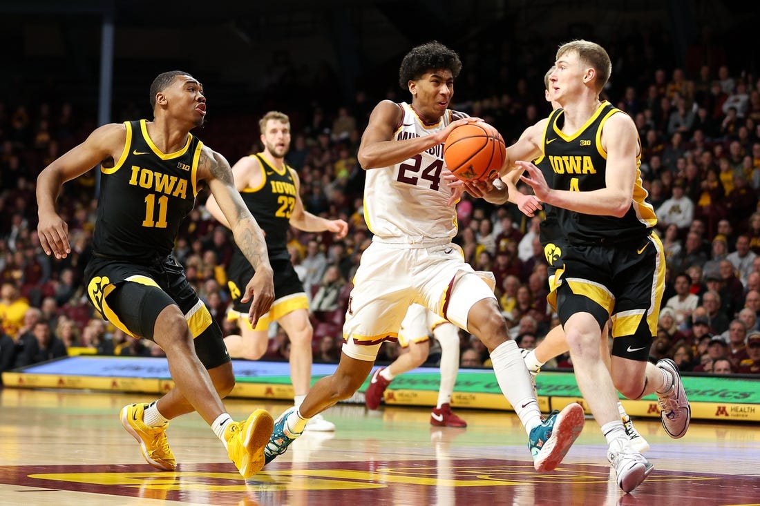 Jan 15, 2024; Minneapolis, Minnesota, USA; Minnesota Golden Gophers guard Cam Christie (24) works up court as Iowa Hawkeyes guard Josh Dix (4) and guard Tony Perkins (11) defend during the first half at Williams Arena. Mandatory Credit: Matt Krohn-USA TODAY Sports