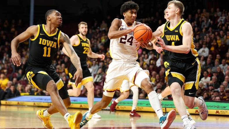 Jan 15, 2024; Minneapolis, Minnesota, USA; Minnesota Golden Gophers guard Cam Christie (24) works up court as Iowa Hawkeyes guard Josh Dix (4) and guard Tony Perkins (11) defend during the first half at Williams Arena. Mandatory Credit: Matt Krohn-USA TODAY Sports