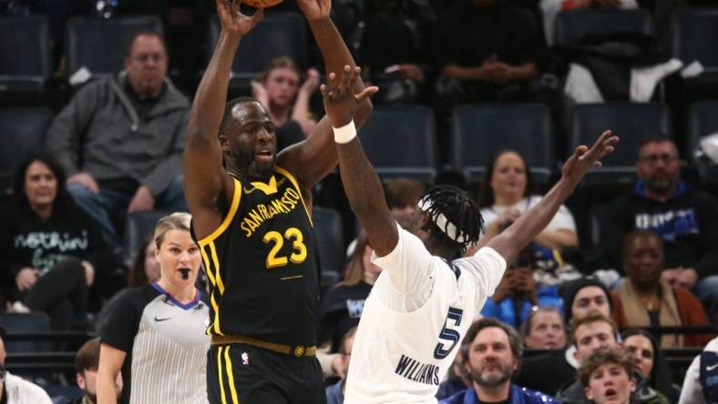 Jan 15, 2024; Memphis, Tennessee, USA; Golden State Warriors forward Draymond Green (23) passes the ball as Memphis Grizzlies guard Vince Williams Jr. (5) defends during the first half at FedExForum. Mandatory Credit: Petre Thomas-USA TODAY Sports