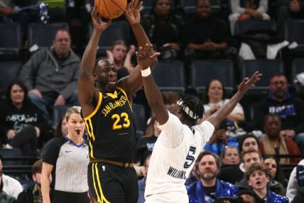 Jan 15, 2024; Memphis, Tennessee, USA; Golden State Warriors forward Draymond Green (23) passes the ball as Memphis Grizzlies guard Vince Williams Jr. (5) defends during the first half at FedExForum. Mandatory Credit: Petre Thomas-USA TODAY Sports