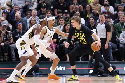 Jan 15, 2024; Salt Lake City, Utah, USA; Utah Jazz forward Lauri Markkanen (23) looks to drive against Indiana Pacers guard Buddy Hield (7) and guard Andrew Nembhard (2) during the second quarter at Delta Center. Mandatory Credit: Rob Gray-USA TODAY Sports