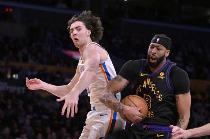 Jan 15, 2024; Los Angeles, California, USA;   Oklahoma City Thunder guard Josh Giddey (3) and Los Angeles Lakers forward Anthony Davis (3) go for a rebound in the first half at Crypto.com Arena. Mandatory Credit: Jayne Kamin-Oncea-USA TODAY Sports