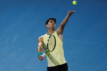 Jan 16, 2024; Melbourne, Victoria, Australia;   Carlos Alcaraz of Spain hits a shot against Richard Gasquet of France in the first round of the men s singles at the Australian Open. Mandatory Credit: Mike Frey-USA TODAY Sports