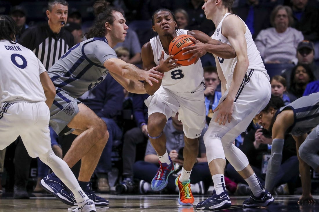 Jan 16, 2024; Cincinnati, Ohio, USA; Xavier Musketeers guard Quincy Olivari (8) dribbles against Butler Bulldogs forward Boden Kapke (33) in the first half at Cintas Center. Mandatory Credit: Katie Stratman-USA TODAY Sports