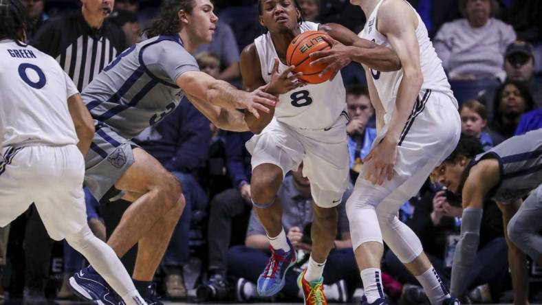 Jan 16, 2024; Cincinnati, Ohio, USA; Xavier Musketeers guard Quincy Olivari (8) dribbles against Butler Bulldogs forward Boden Kapke (33) in the first half at Cintas Center. Mandatory Credit: Katie Stratman-USA TODAY Sports