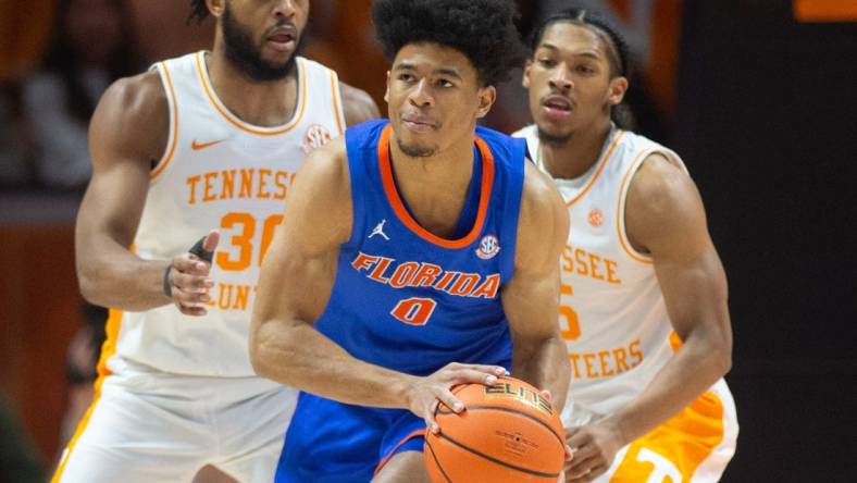 Florida's Zyon Pullin (0) is pressed guarded by Tennessee's Josiah-Jordan James (30) and Zakai Zeigler (5) during an NCAA basketball game on Tuesday, January 16, 2024 in Knoxville, Tenn.