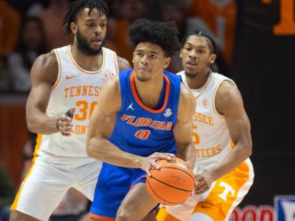 Florida's Zyon Pullin (0) is pressed guarded by Tennessee's Josiah-Jordan James (30) and Zakai Zeigler (5) during an NCAA basketball game on Tuesday, January 16, 2024 in Knoxville, Tenn.