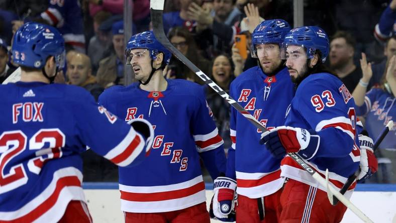 Jan 16, 2024; New York, New York, USA; New York Rangers right wing Blake Wheeler (17) celebrates his empty net goal against the Seattle Kraken with defenseman Adam Fox (23) and left wing Chris Kreider (20) and center Mika Zibanejad (93) during the third period at Madison Square Garden. Mandatory Credit: Brad Penner-USA TODAY Sports