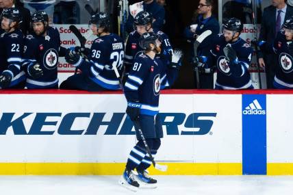 Jan 16, 2024; Winnipeg, Manitoba, CAN; Winnipeg Jets forward Kyle Connor (81) is congratulated by his teammates on his goal against the New York Islanders during the third period at Canada Life Centre. Mandatory Credit: Terrence Lee-USA TODAY Sports