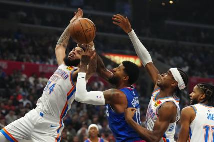 Jan 16, 2024; Los Angeles, California, USA; Oklahoma City Thunder forward Kenrich Williams (34) and guard Shai Gilgeous-Alexander (2) battle for the ball with LA Clippers forward Paul George (13) in the first half at Crypto.com Arena. Mandatory Credit: Kirby Lee-USA TODAY Sports