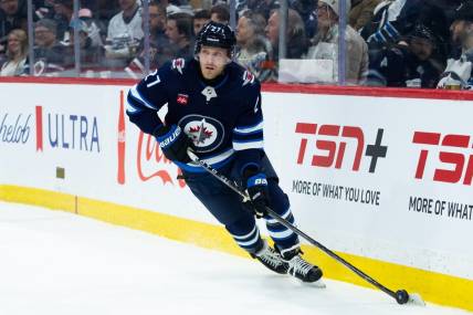 Jan 16, 2024; Winnipeg, Manitoba, CAN; Winnipeg Jets forward Nikolaj Ehlers (27) looks to make a pass against the New York Islanders during the first period at Canada Life Centre. Mandatory Credit: Terrence Lee-USA TODAY Sports