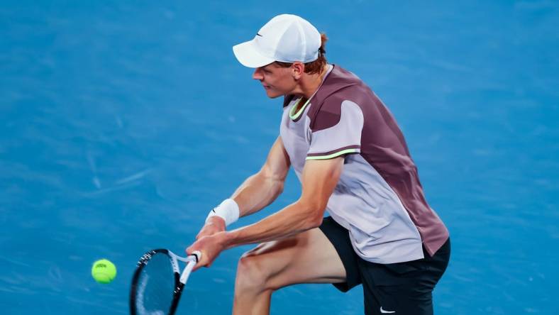 Jan 17, 2024; Melbourne, Victoria, Australia; Jannik Sinner of Italy plays a shot against Jesper de Jong (not pictured) of Netherlands in Round 2 of the Men's Singles on Day 4 of the Australian Open tennis at Rod Laver Arena.Mandatory Credit: Mike Frey-USA TODAY Sports