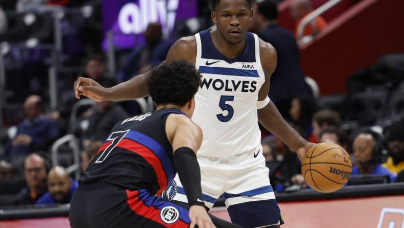 Jan 17, 2024; Detroit, Michigan, USA;  Minnesota Timberwolves guard Anthony Edwards (5) dribbles defended by Detroit Pistons guard Killian Hayes (7) in the first half at Little Caesars Arena. Mandatory Credit: Rick Osentoski-USA TODAY Sports