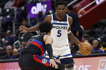 Jan 17, 2024; Detroit, Michigan, USA;  Minnesota Timberwolves guard Anthony Edwards (5) dribbles defended by Detroit Pistons guard Killian Hayes (7) in the first half at Little Caesars Arena. Mandatory Credit: Rick Osentoski-USA TODAY Sports