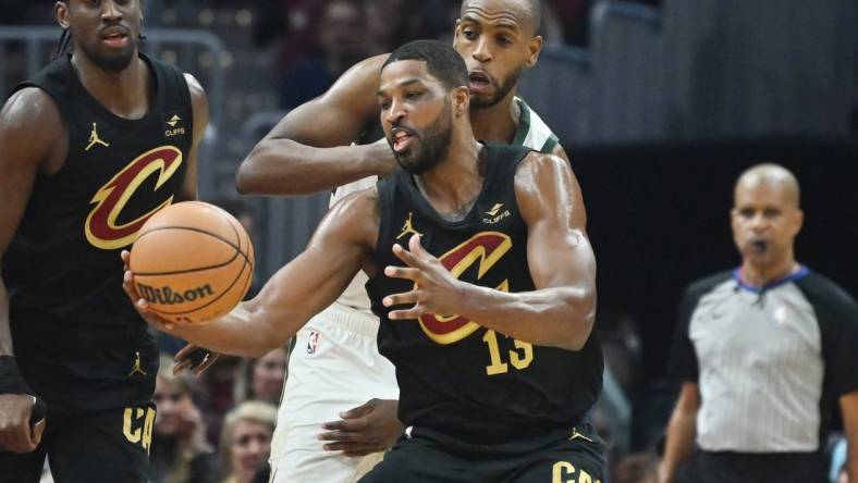 Jan 17, 2024; Cleveland, Ohio, USA; Milwaukee Bucks forward Khris Middleton (22) goes for a loose ball against Cleveland Cavaliers center Tristan Thompson (13) during the first half at Rocket Mortgage FieldHouse. Mandatory Credit: Ken Blaze-USA TODAY Sports