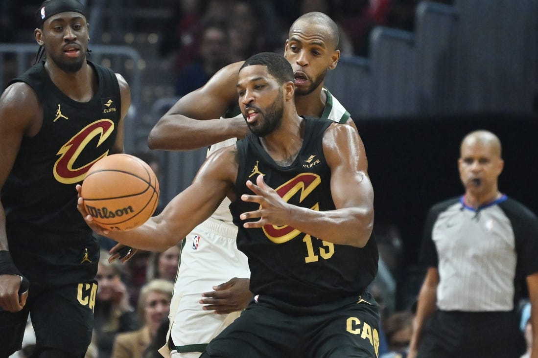 Jan 17, 2024; Cleveland, Ohio, USA; Milwaukee Bucks forward Khris Middleton (22) goes for a loose ball against Cleveland Cavaliers center Tristan Thompson (13) during the first half at Rocket Mortgage FieldHouse. Mandatory Credit: Ken Blaze-USA TODAY Sports