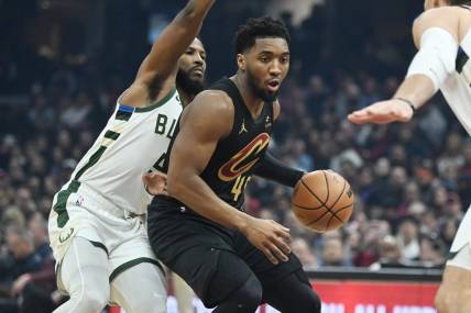 Jan 17, 2024; Cleveland, Ohio, USA; Cleveland Cavaliers guard Donovan Mitchell (45) drives to the basket against Milwaukee Bucks guard Malik Beasley (5) during the first half at Rocket Mortgage FieldHouse. Mandatory Credit: Ken Blaze-USA TODAY Sports