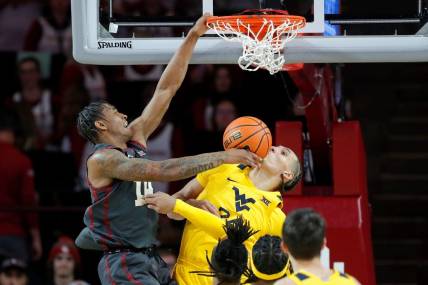 Oklahoma Sooners forward Jalon Moore (14) dunks the ball on West Virginia Mountaineers forward Patrick Suemnick (24) during a college basketball game between the University of Oklahoma Sooners (OU) and the West Virginia Mountaineers at Lloyd Noble Center in Norman, Okla., Okla., Wednesday, Jan. 17, 2024.